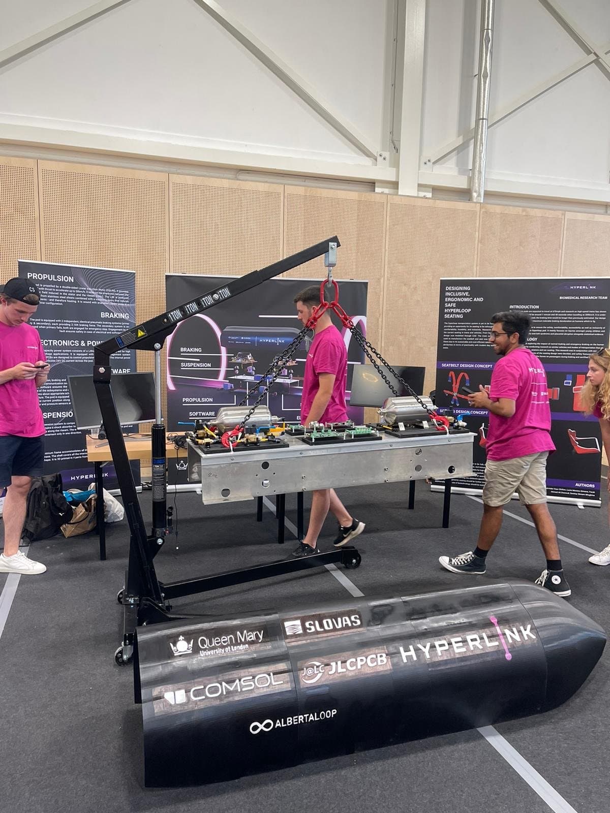 Hyperlink team and pod at workshop – gantry crane, electronics module, and display boards